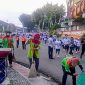 Petugas kebersihan Dinas Lingkungan Hidup DLH Kota Bandar Lampung membersihkan jalur BDL Color Run 2026 di tengah keramaian peserta, Minggu 21/6/2026. Sebanyak 154 petugas dikerahkan untuk menjaga kebersihan kota selama acara HUT ke-344 Bandar Lampung. PROYEKSI.ID